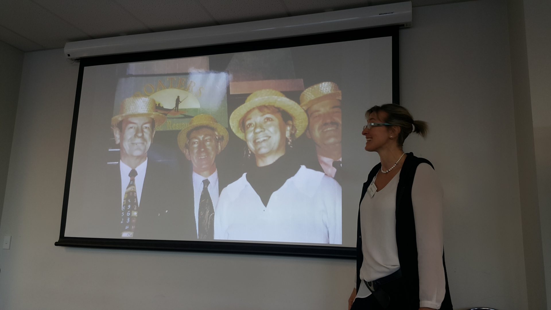 woman presenting a slide showing a group of four people