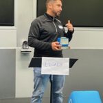 Man speaking animatedly from behind a lectern