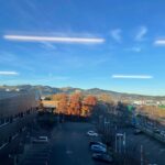 View of a car park and hilltop in the background from a high rise at sunrise