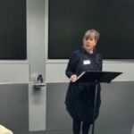 Woman standing behind the lectern